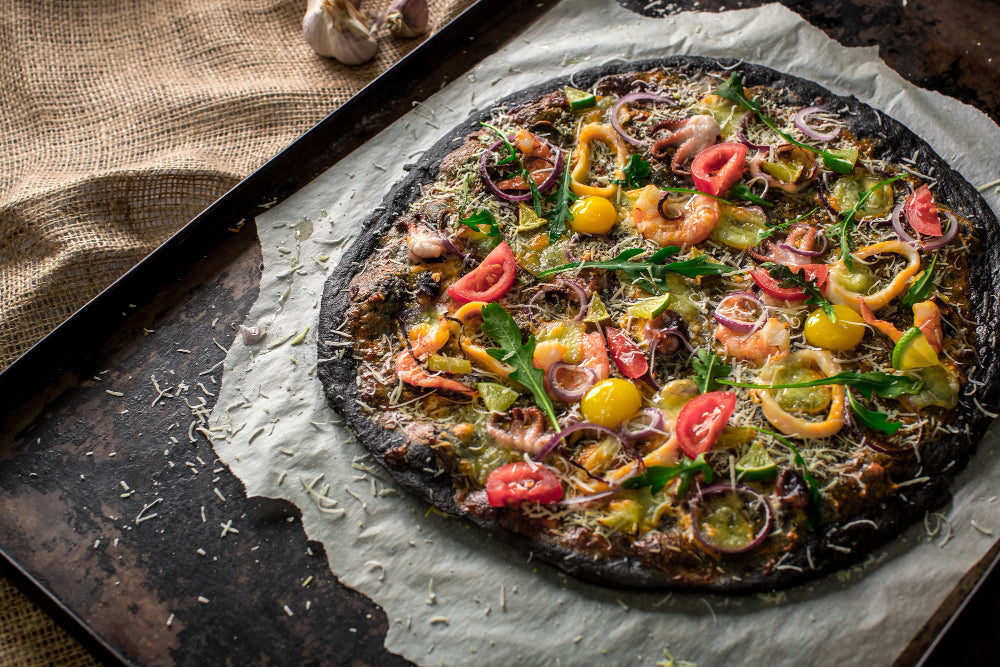 Black wheat veggie-loaded pizza